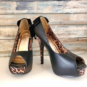 Black 4 inch platform animal print heels, size 7